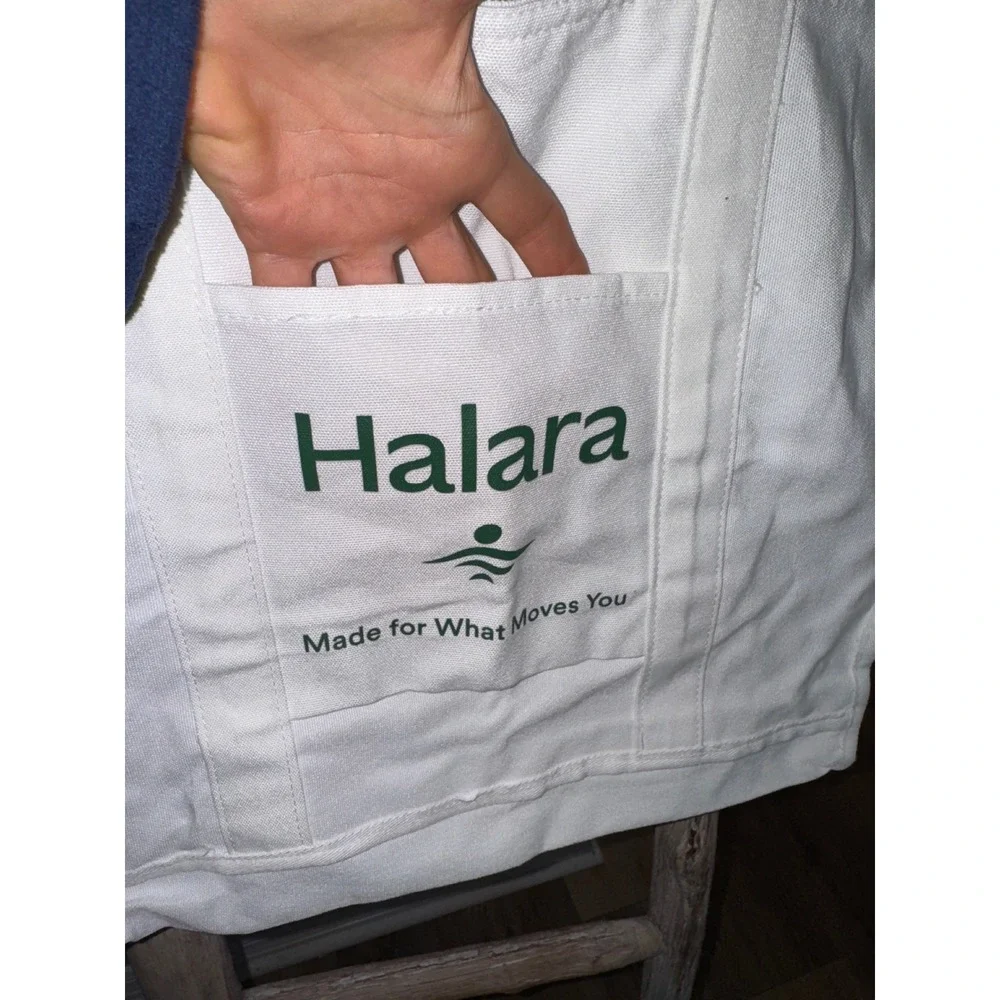 Women's white Halara canvas tote bag with a‎ green logo and text NWT travel gym